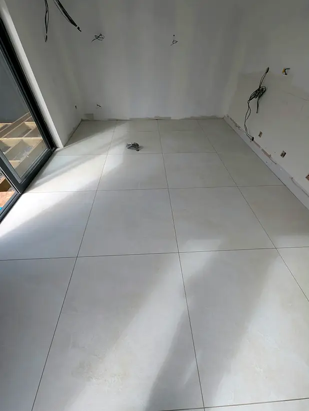 Large format floor tiles in a bright room